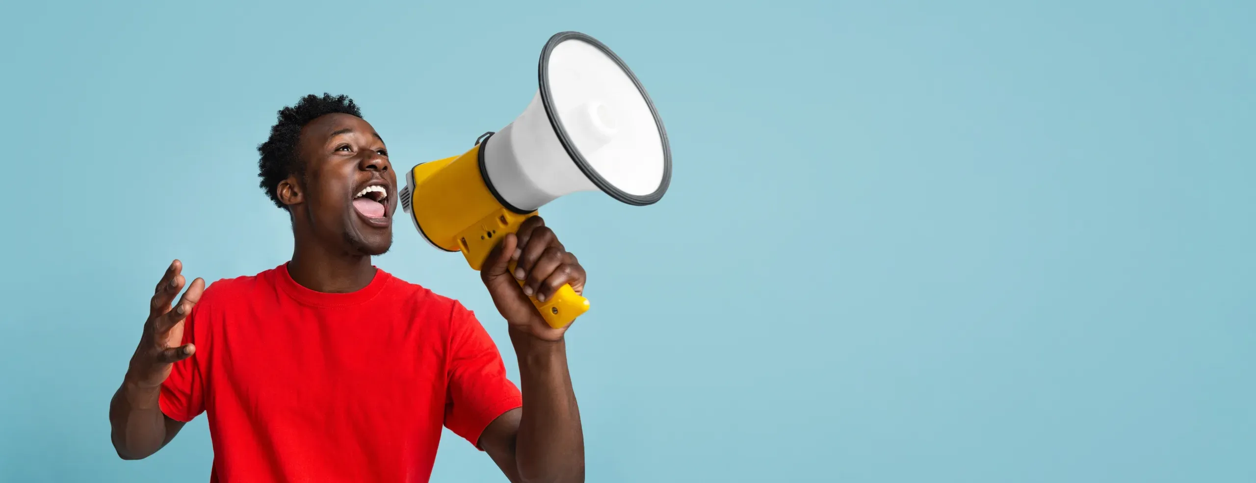 Emotional,Young,Black,Guy,Making,Announcement,With,Megaphone,In,Hands,